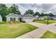 Charming home featuring a well-manicured lawn, a two car garage, and tasteful landscaping at 4511 Hunton Dale Nw Rd, Concord, NC 28027