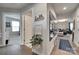 Hallway featuring hardwood floors, decorative wall accents, and an open view into the living room at 4511 Hunton Dale Nw Rd, Concord, NC 28027