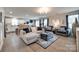 Open-concept living room with hardwood floors, modern furniture, and ample natural light at 4511 Hunton Dale Nw Rd, Concord, NC 28027