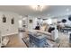 Open-concept living room with modern furnishings flowing into the kitchen at 4511 Hunton Dale Nw Rd, Concord, NC 28027