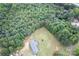 Aerial view showcasing a home's peaceful, private setting surrounded by dense trees at 4630 Irish Potato Rd, Kannapolis, NC 28083