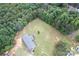 Aerial view of a house surrounded by lush greenery and mature trees at 4630 Irish Potato Rd, Kannapolis, NC 28083