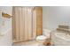 Bathroom features a shower, vanity, and toilet with light wood paneling at 4630 Irish Potato Rd, Kannapolis, NC 28083