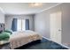 Bedroom with a large bed, side table, and ample natural light from the windows at 4630 Irish Potato Rd, Kannapolis, NC 28083