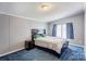 Bedroom with a large bed, side table, and ample natural light from the windows at 4630 Irish Potato Rd, Kannapolis, NC 28083