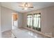 Cozy bedroom featuring light-filled windows and a ceiling fan for added comfort and ventilation at 4630 Irish Potato Rd, Kannapolis, NC 28083