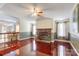 Inviting living room with a stone fireplace, hardwood floors, and an open layout to the kitchen at 4630 Irish Potato Rd, Kannapolis, NC 28083