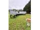 Backyard view featuring a deck connected to the house and a bird bath on a grassy lawn at 5022 Wrenn Dr, Denver, NC 28037