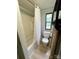 Cozy bathroom featuring a shower-tub combo, toilet, and a small window offering natural light at 5022 Wrenn Dr, Denver, NC 28037