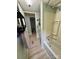 Bathroom showcasing a shower-tub combo and a view of the hallway with neutral flooring at 5022 Wrenn Dr, Denver, NC 28037