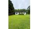 Charming single-story home with fresh green lawn and mature trees at 5022 Wrenn Dr, Denver, NC 28037