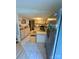 Efficient kitchen with white cabinets, stainless steel refrigerator, and tiled floor at 5022 Wrenn Dr, Denver, NC 28037