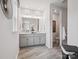 Bathroom featuring double vanity with elegant gray cabinets and marble floors at 507 Webster Ln, Cramerton, NC 28032
