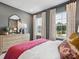 Charming bedroom featuring large windows, stylish décor, and a comfortable bed with decorative pillows at 507 Webster Ln, Cramerton, NC 28032