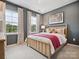 Cozy bedroom featuring a comfortable bed, soft carpet, and bright natural light from the large windows at 507 Webster Ln, Cramerton, NC 28032