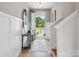 Inviting entryway with light wood floors, neutral walls, decorative table, and an open door to the outdoors at 507 Webster Ln, Cramerton, NC 28032