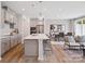 Open kitchen with a large island, pendant lights, stainless steel appliances, and light gray cabinetry at 507 Webster Ln, Cramerton, NC 28032