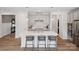 Bright kitchen with a large island, pendant lighting, stainless steel appliances, and modern light gray cabinetry at 507 Webster Ln, Cramerton, NC 28032