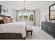 Bright main bedroom with large windows, a king bed, and decorative furnishings at 507 Webster Ln, Cramerton, NC 28032