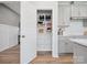 Walk-in pantry with wire shelving and open door next to modern kitchen cabinetry at 507 Webster Ln, Cramerton, NC 28032