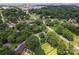 Aerial view of the neighborhood showing the house with a pool surrounded by mature trees and lawns at 6313 Weddington Rd, Concord, NC 28027