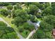 Expansive aerial view of a home surrounded by mature trees, showcasing a pool and lush greenery at 6313 Weddington Rd, Concord, NC 28027