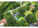 Aerial view of a beautiful property featuring a large pool, mature trees, and a well-maintained lawn at 6313 Weddington Rd, Concord, NC 28027