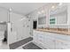 This renovated bathroom has a walk-in shower and a double vanity with granite countertops at 6313 Weddington Rd, Concord, NC 28027