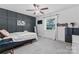 This bedroom features a dark accent wall, a ceiling fan, and a window for natural light at 6313 Weddington Rd, Concord, NC 28027