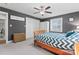 Well-lit bedroom featuring a stylish bed frame, neutral carpet, and ample closet space for storage at 6313 Weddington Rd, Concord, NC 28027