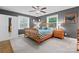 Stylish bedroom with wood bed frame, neutral carpet, and plenty of natural light from two large windows at 6313 Weddington Rd, Concord, NC 28027