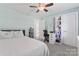 This bedroom has a light green color scheme, a ceiling fan, and a small desk at 6313 Weddington Rd, Concord, NC 28027