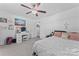 This bedroom features white walls, a ceiling fan, and a vanity at 6313 Weddington Rd, Concord, NC 28027