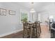 Cozy dining room with a wooden table set for four, bathed in natural light from the nearby window at 6313 Weddington Rd, Concord, NC 28027