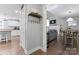 Welcoming entryway leading to a modern kitchen and living room with hardwood floors and natural light at 6313 Weddington Rd, Concord, NC 28027