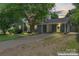 Attractive home featuring a covered carport and a well-manicured front yard with mature landscaping at 6313 Weddington Rd, Concord, NC 28027