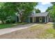 Charming home featuring a covered carport and a well-manicured front yard with mature landscaping at 6313 Weddington Rd, Concord, NC 28027