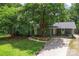 Inviting home exterior showcasing a well-maintained lawn, mature trees, and a welcoming front entrance at 6313 Weddington Rd, Concord, NC 28027