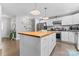 Modern kitchen featuring an island, stainless steel appliances, and sleek white cabinets at 6313 Weddington Rd, Concord, NC 28027