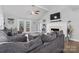 Comfortable living room with a cozy fireplace, plush seating, and French doors leading to the outdoors at 6313 Weddington Rd, Concord, NC 28027