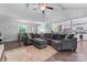 Spacious living room with a large sectional sofa, hardwood floors, and seamless flow into the dining area at 6313 Weddington Rd, Concord, NC 28027