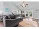 Inviting living room featuring a large sectional sofa, hardwood floors, and a bright view into the kitchen at 6313 Weddington Rd, Concord, NC 28027