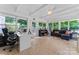 Bright sunroom featuring a neutral tile floor, large windows offering great outdoor views and neutral color scheme at 6313 Weddington Rd, Concord, NC 28027