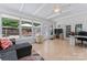 Light-filled sunroom with tile flooring, large windows overlooking the backyard, and comfortable seating area at 6313 Weddington Rd, Concord, NC 28027