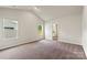 Large bedroom with vaulted ceiling, plush carpet, neutral walls and natural light from two windows at 7217 Jerimoth Dr, Charlotte, NC 28215