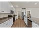 Stylish kitchen featuring granite countertops, stainless steel appliances, and white cabinets at 7217 Jerimoth Dr, Charlotte, NC 28215