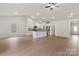 Spacious open-concept living area featuring wood-look flooring, a kitchen island, and modern appliances at 7217 Jerimoth Dr, Charlotte, NC 28215