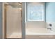 Bright bathroom featuring a tub and separate tiled shower with glass door at 8044 Hawk Crest Ct, Charlotte, NC 28270