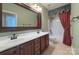 Bathroom featuring a double vanity and a large mirror and shower over tub at 8044 Hawk Crest Ct, Charlotte, NC 28270