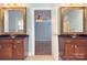 Bright bathroom features double vanities with granite countertops, plus decorative framed mirrors and fixtures at 8044 Hawk Crest Ct, Charlotte, NC 28270